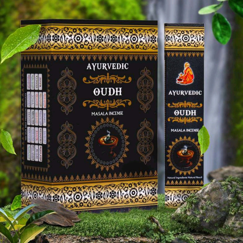 Ayurvedic Oudh Masala Incense packaging with green leaves and smoke in the background