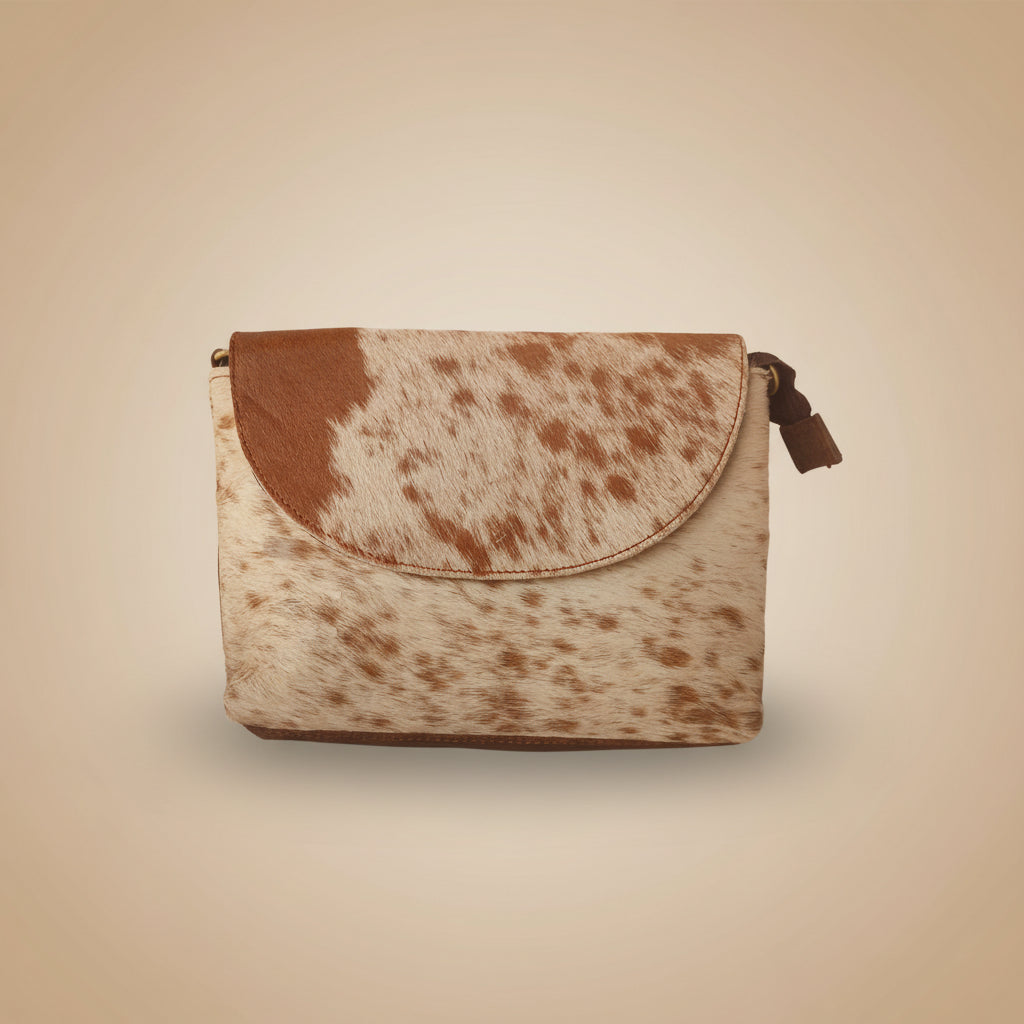 Cow print pouch on a beige background