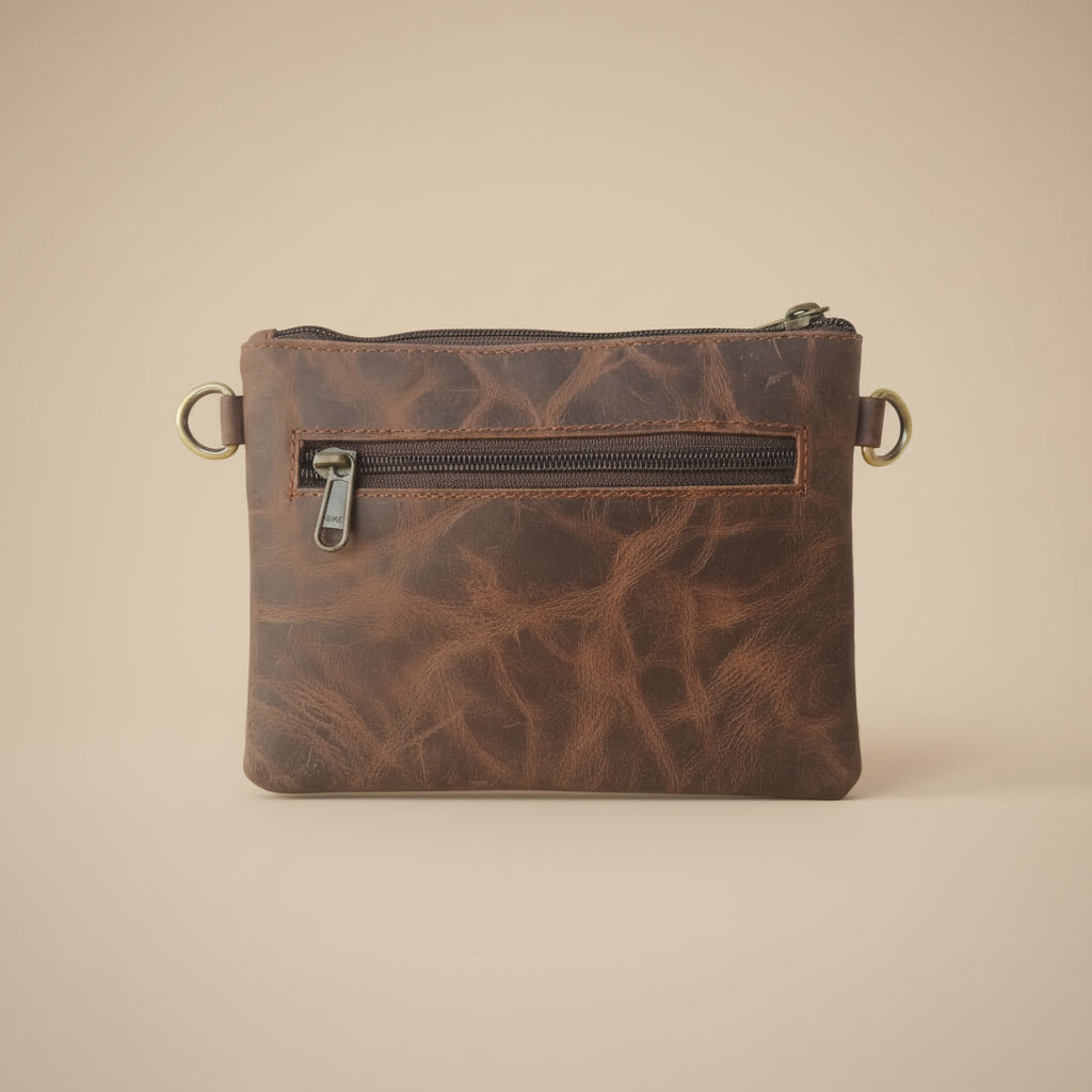 Brown leather pouch with zipper on a light gray background