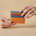 Multicolored striped wallet on a light gray background