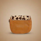 Brown leather pouch with leopard print strap on a light gray background