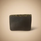 Black leather case with leopard print trim on a white background