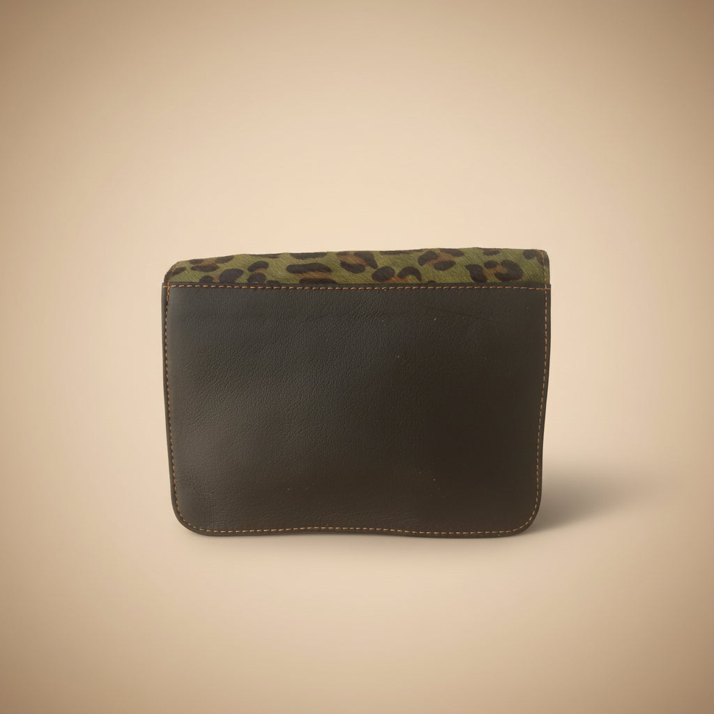 Black leather case with leopard print trim on a white background