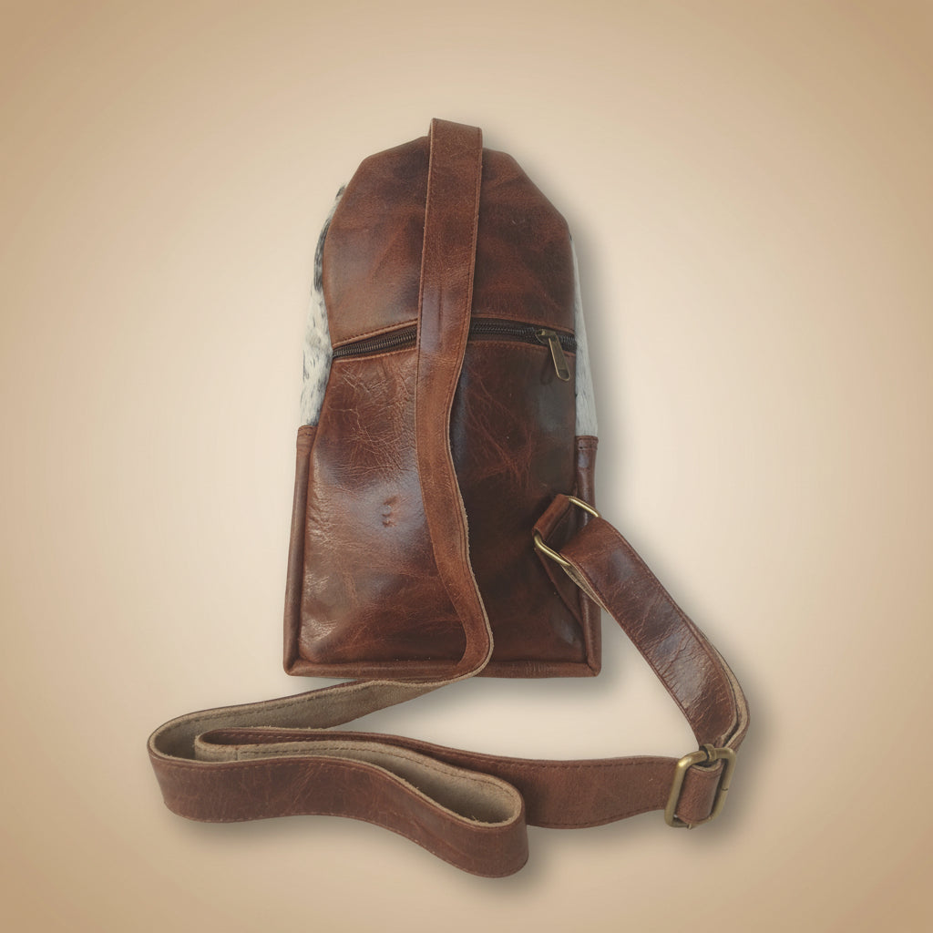 Brown leather bag with strap on a white background