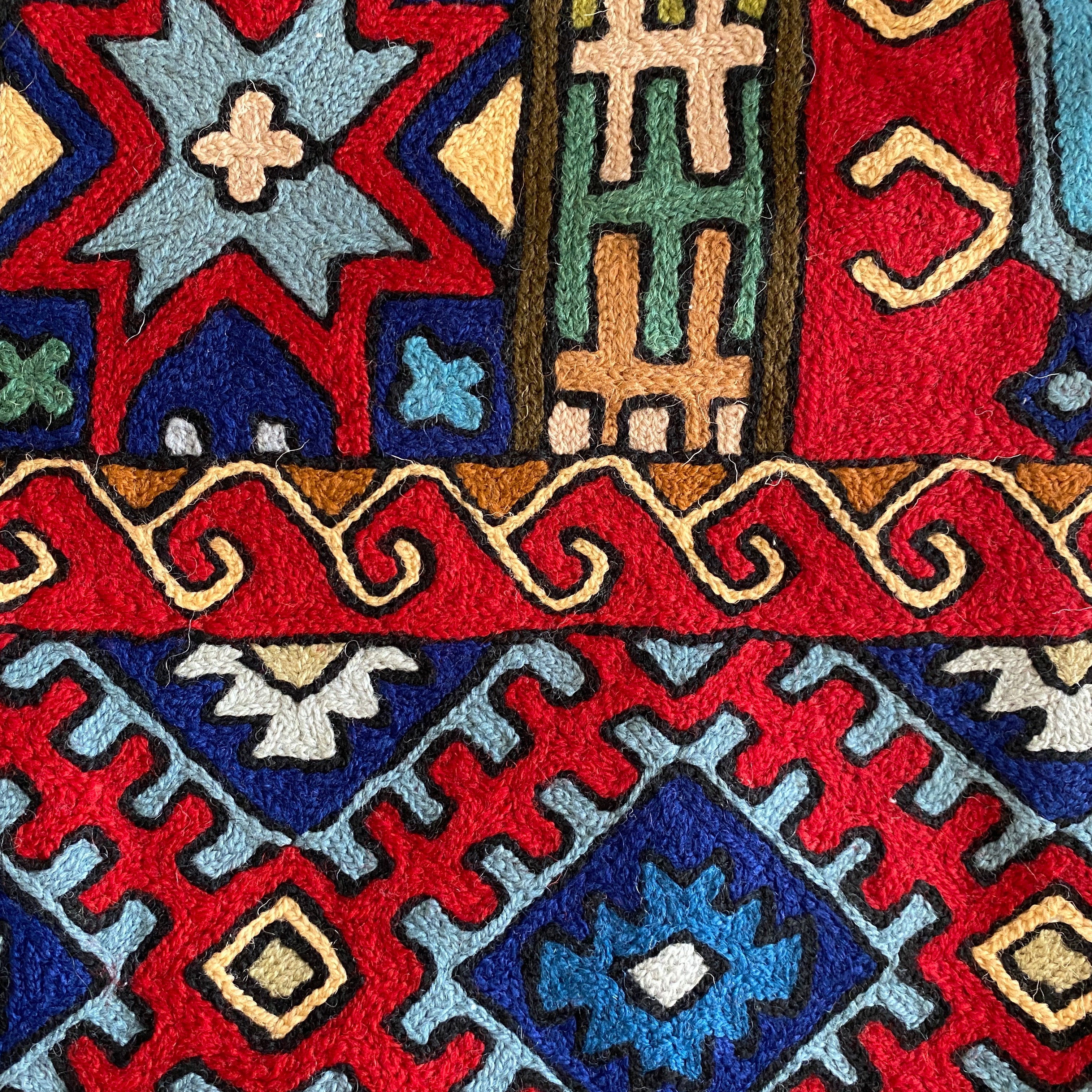 Two colorful geometric-patterned rugs with intricate designs.