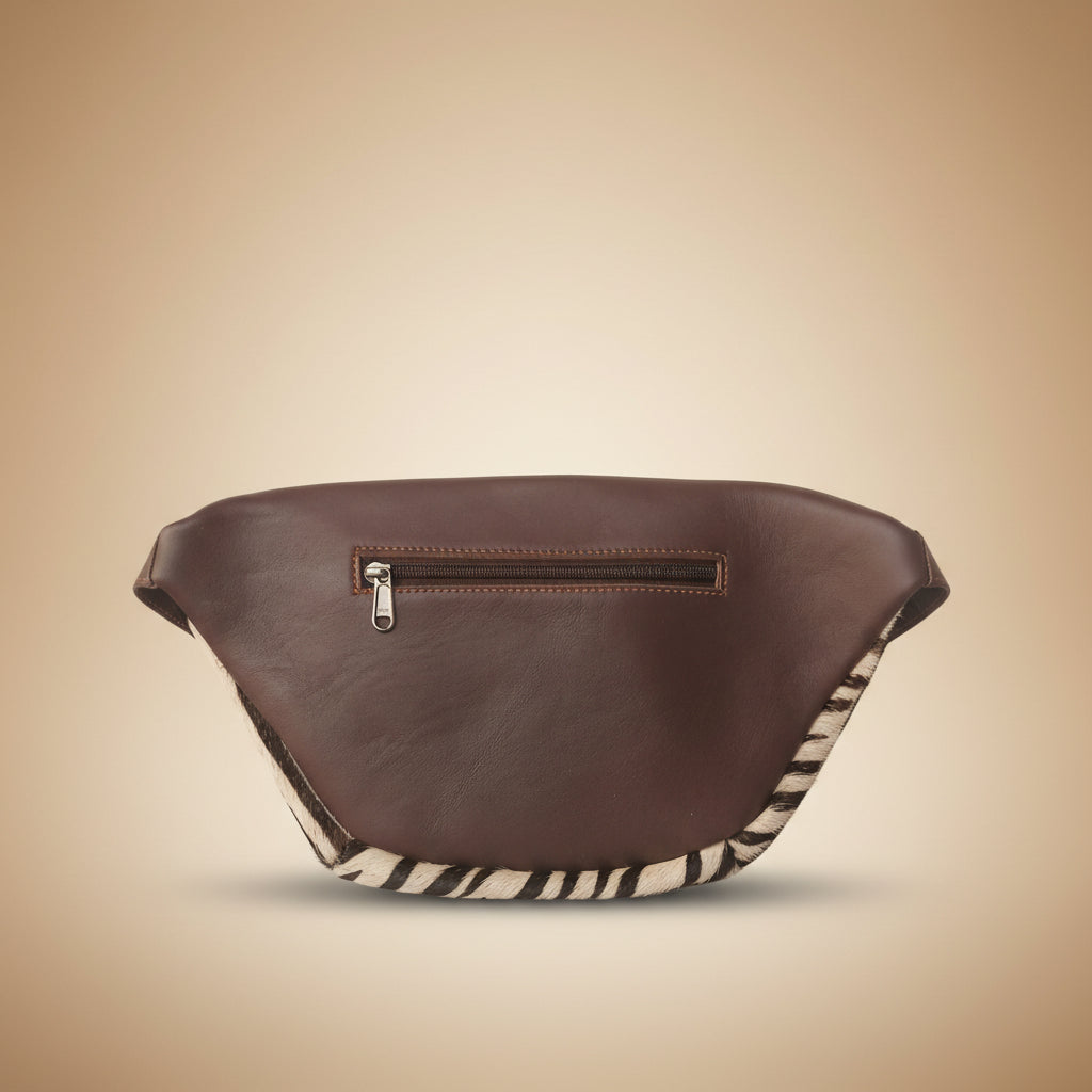 Brown leather saddle pad with zebra pattern on a light gray background