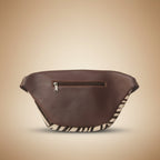 Brown leather saddle pad with zebra pattern on a light gray background