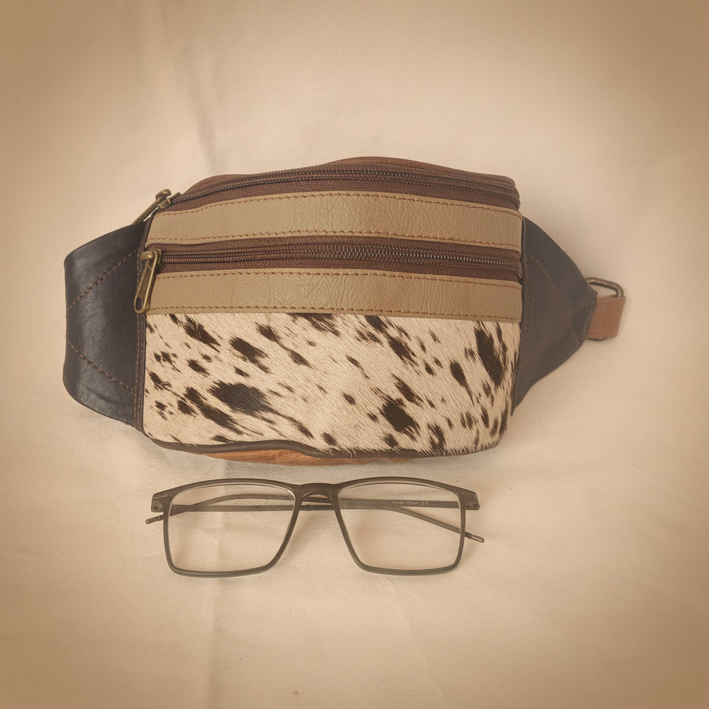 Multicolored bag with a pattern and a pair of glasses on a white background