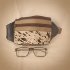Multicolored bag with a pattern and a pair of glasses on a white background