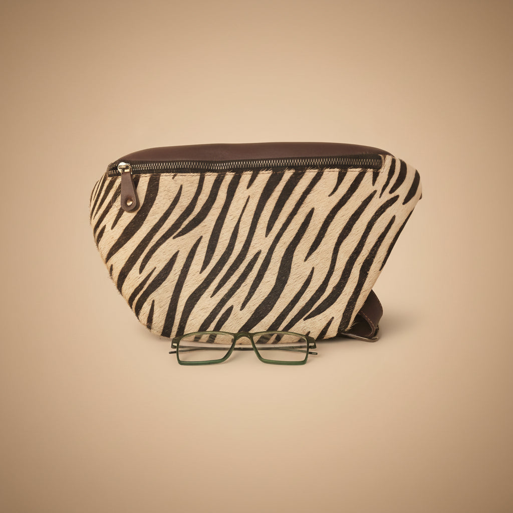 Zebra patterned pouch with a pair of glasses on a white background