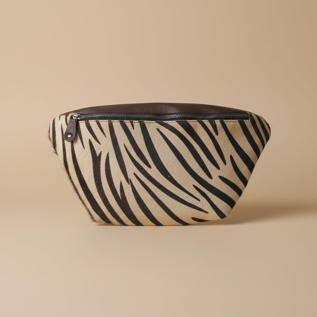 Zebra patterned pouch with a zipper on a white background