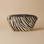 Zebra patterned pouch with a zipper on a white background