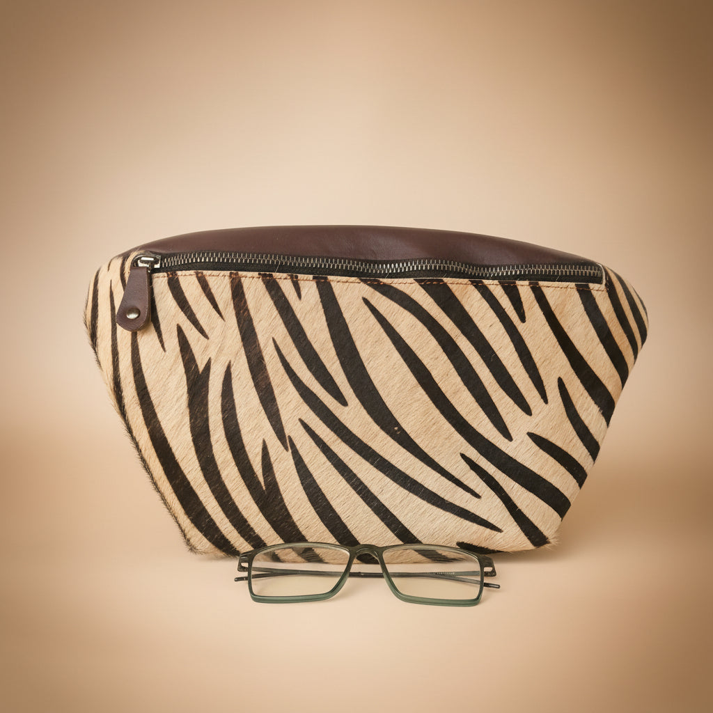 Zebra patterned pouch with a pair of glasses on a light gray background