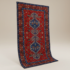 Decorative red and blue patterned rug on a beige background