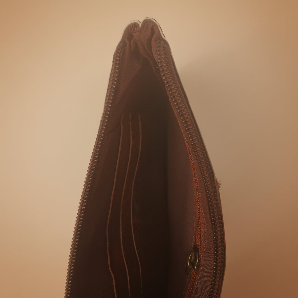 Brown leather wallet with zipper on a white background