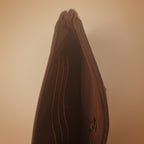 Brown leather wallet with zipper on a white background