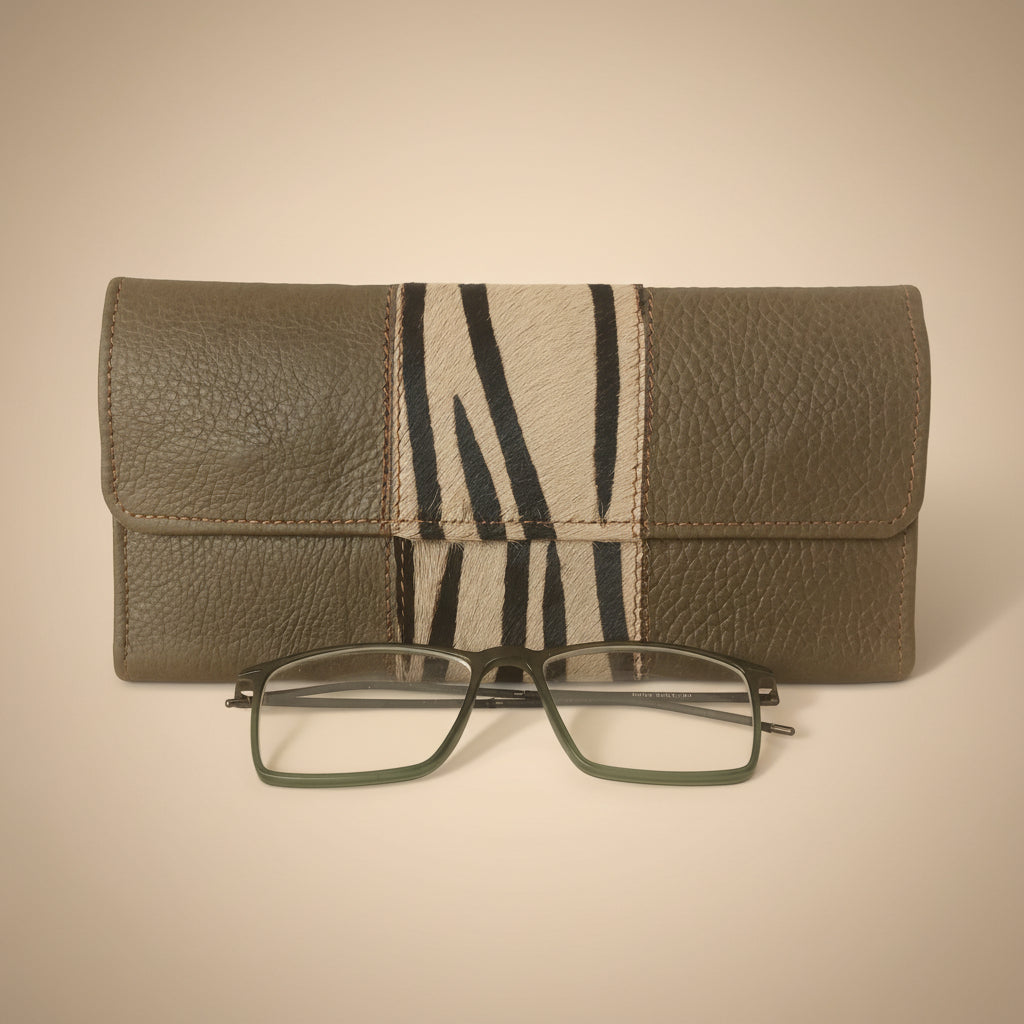 Gray eyeglass case with zebra pattern and glasses on a white background