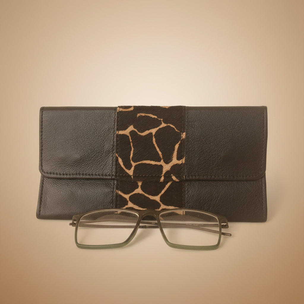 Black leather wallet with giraffe pattern and glasses on a white background
