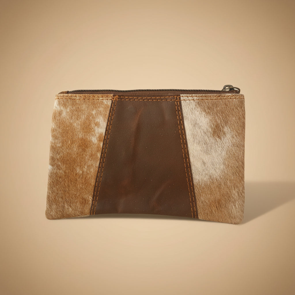 Brown leather pouch with cowhide pattern on a beige background