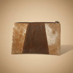 Brown leather pouch with cowhide pattern on a beige background