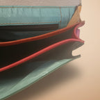 Close-up of a textured surface with a zipper and colorful interior
