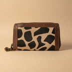 Wallet with giraffe pattern on a light gray background
