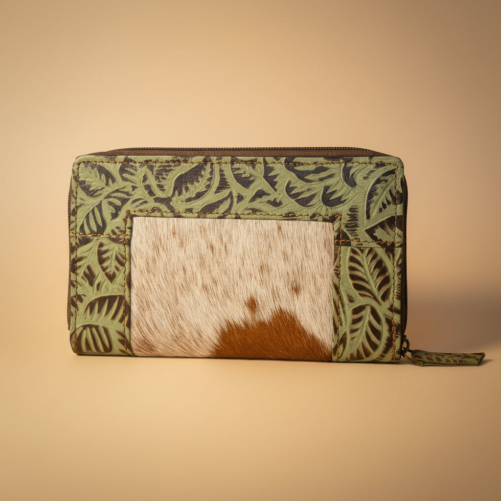 Small pouch with green leaf pattern and brown and white cowhide material on a white background