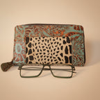 Leopard print case with a patterned top and eyeglasses on a white background