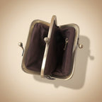 Brown leather purse with metal clasp on a white background
