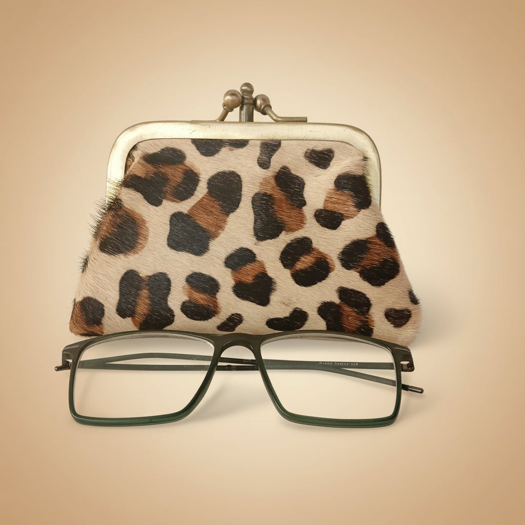 Leopard print case with glasses on a light gray background
