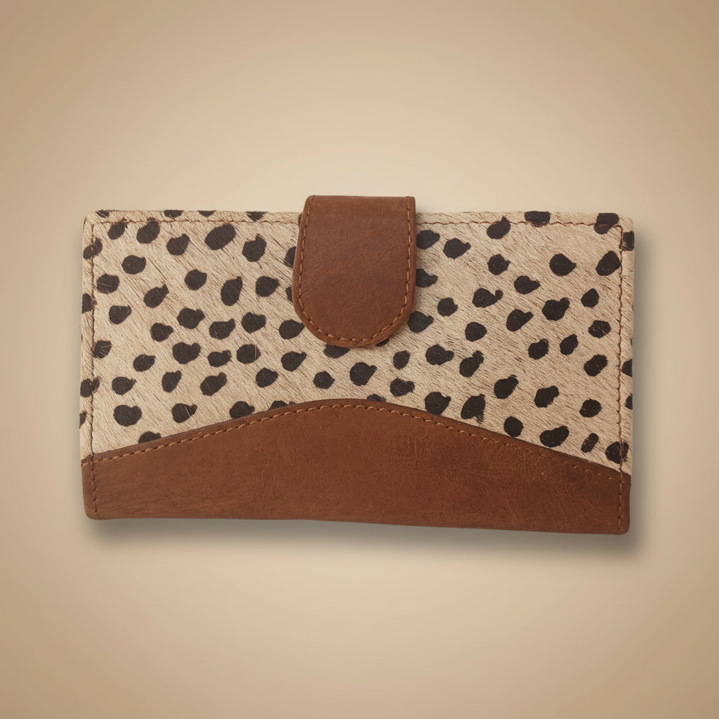 WALLET CLUTCH with spotted pattern and brown leather accents on a light gray background