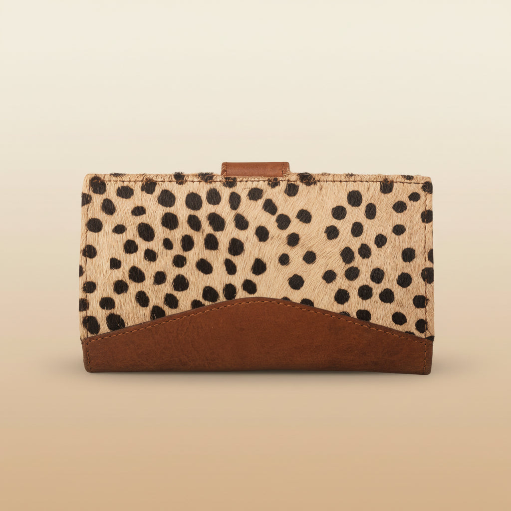 Cardholder with spotted pattern and brown leather accents on a light gray background