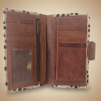 Brown leather wallet with a patterned flap on a white background
