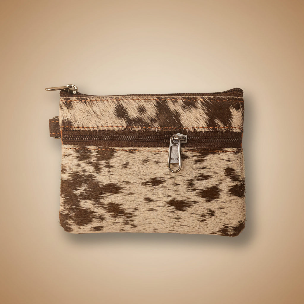 Small pouch with cowhide pattern and zipper on a light gray background