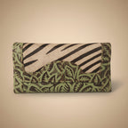 Folded fabric with green and brown pattern on a white background
