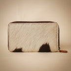 Zipped pouch with cowhide leather texture on a light gray background