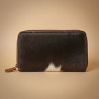 Black and brown hair-on-hide leather wallet on a white background