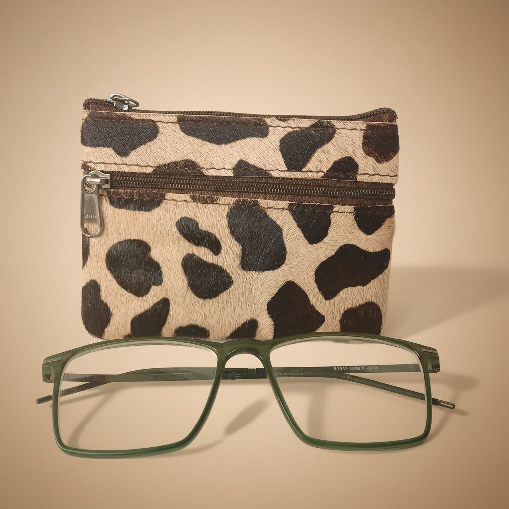 Leopard print pouch with a pair of glasses on a light gray background