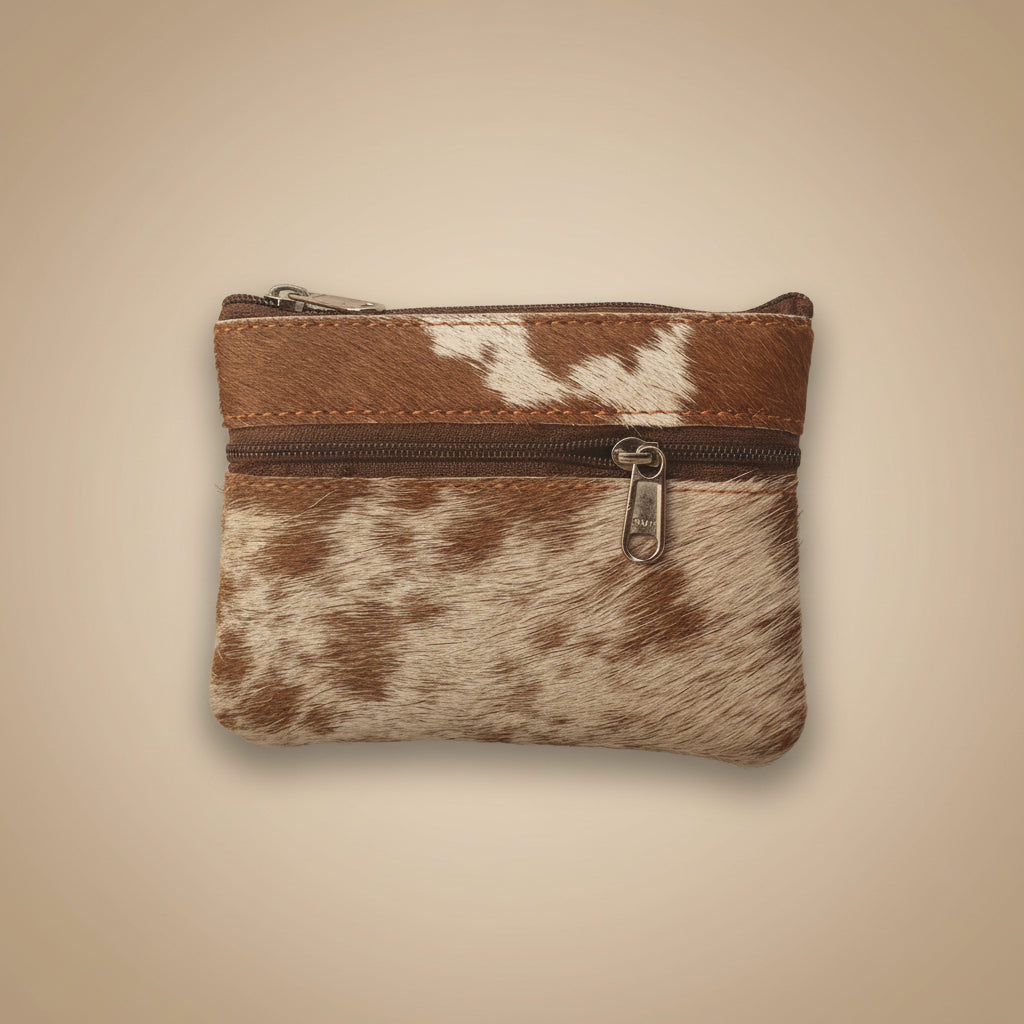 Small pouch with brown and white cowhide pattern and zipper on a light gray background