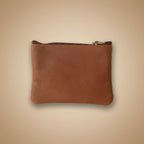 Brown leather pouch with a zipper on a light gray background