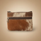 Small pouch with brown and white fur texture and a zipper on a light gray background