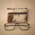 Small pouch with a zipper and a pair of glasses on a light gray background