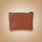 Brown leather pouch with a zipper on a light gray background