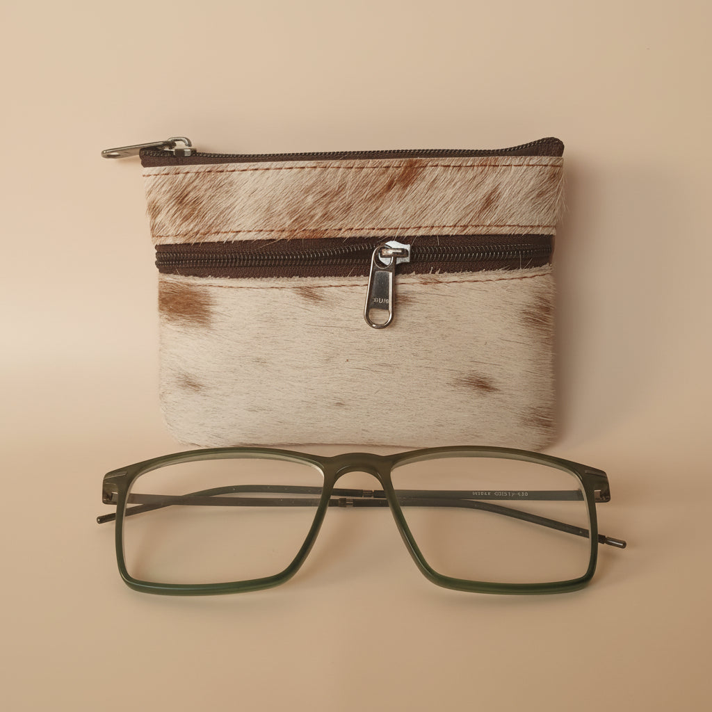 Eyeglasses next to a small pouch on a textured surface