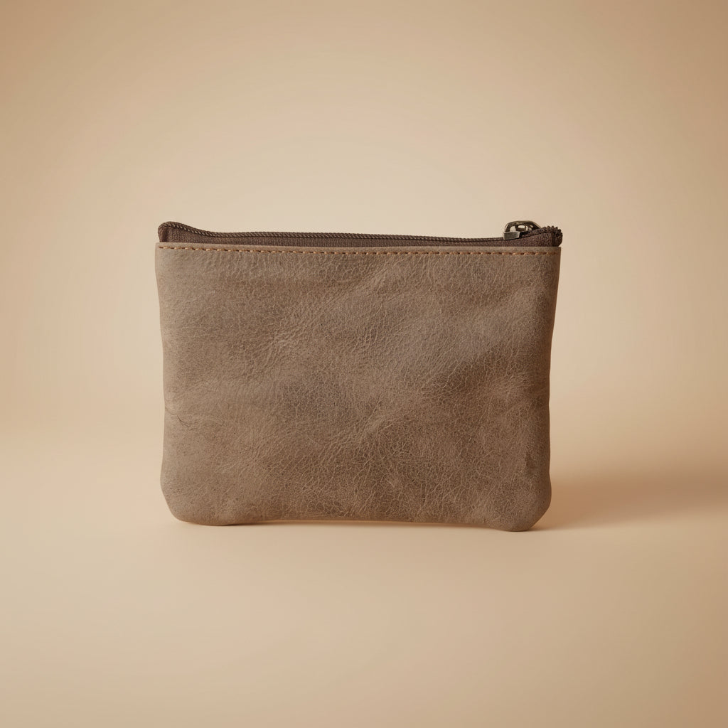 Brown suede pouch with a zipper on a white background