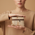 Person holding a small, rustic-style bag with a neutral background