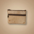 Small leather wallet with a zipper on a light gray background