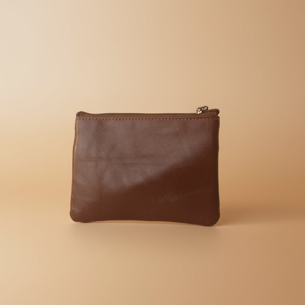Brown leather pouch on a light gray background