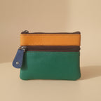 Three-tone leather pouch with zipper on a light gray background