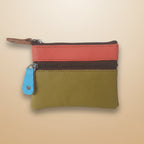 Two-tone leather wallet with zipper on a light gray background